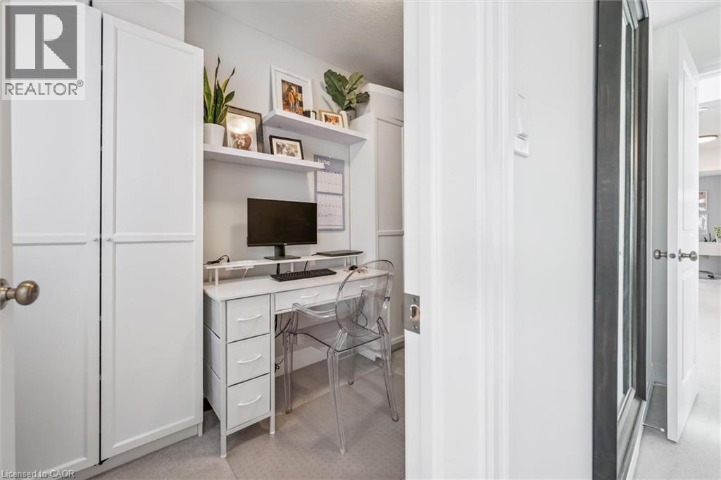 Built-in desk featuring white cabinetry, floating shelves, and recessed lighting - 30 Waterbow Trail, Kitchener, ON - Indoor