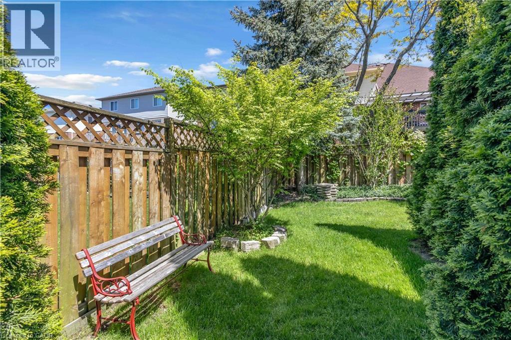 Private backyard space featuring a wooden privacy fence with lattice detail - 640 Acadia Drive, Hamilton, ON