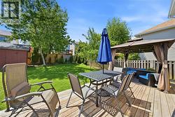 Expansive wood deck featuring a covered gazebo and a separate dining area -