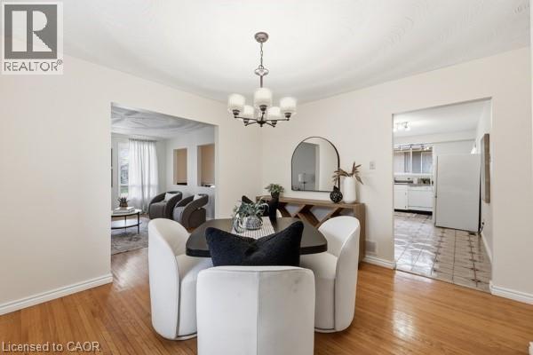 Formal dining area featuring hardwood flooring and an overhead chandelier - 957 Stone Church Road E, Hamilton, ON - Indoor Photo Showing Dining Room
