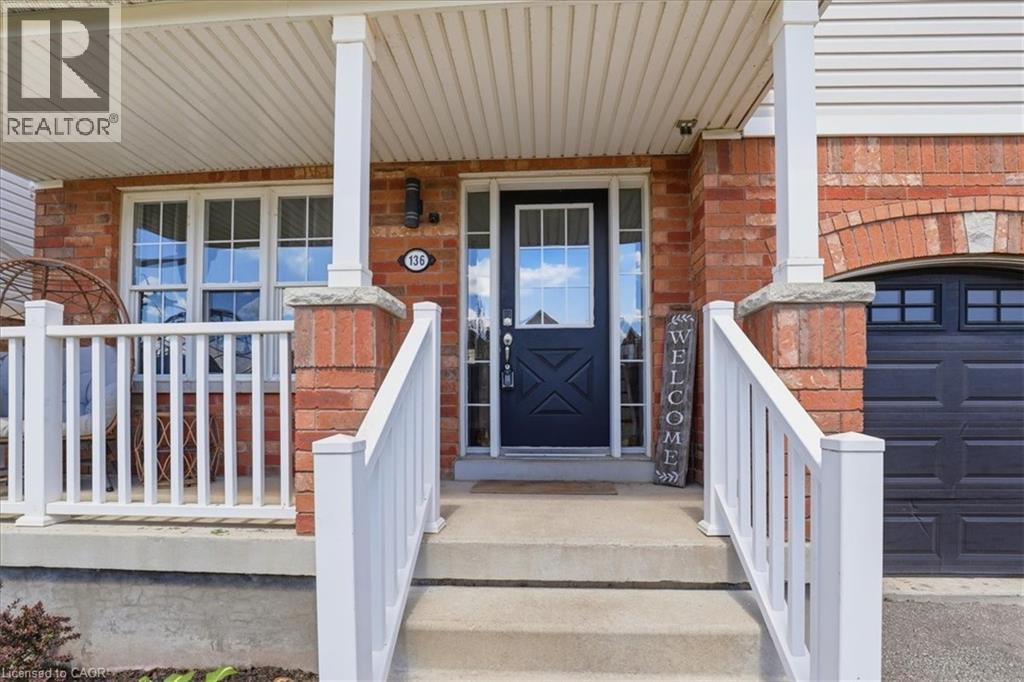 Brick facade entry with a dark paneled front door featuring a divided light window - 136 Carpenter Road, Cambridge, ON - Outdoor With Exterior