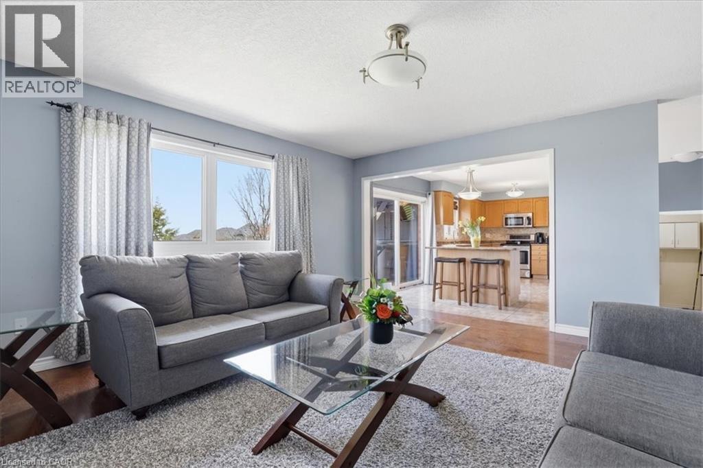 Living area with light blue walls and a large window - 136 Carpenter Road, Cambridge, ON - Indoor Photo Showing Living Room With Fireplace
