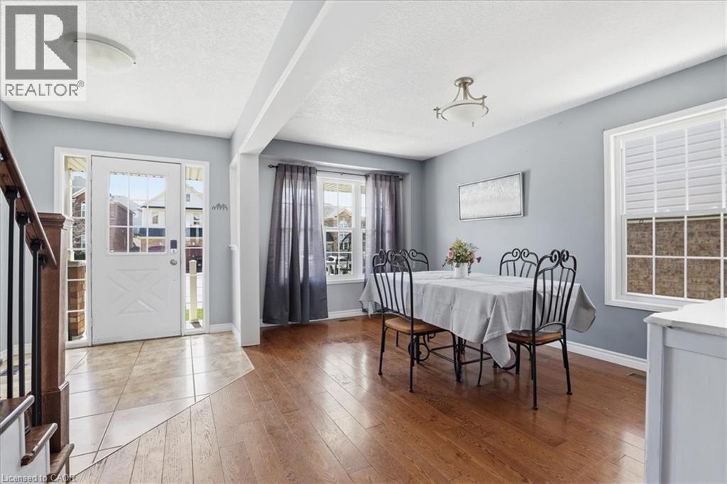 Foyer featuring light-toned tile flooring and a white entry door with frosted glass panes - 136 Carpenter Road, Cambridge, ON - Indoor Photo Showing Bathroom