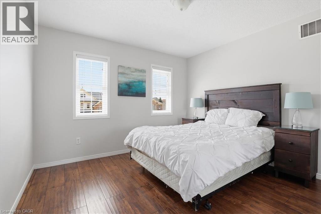 Spacious room featuring wood-finish flooring, light gray walls, and white trim - 136 Carpenter Road, Cambridge, ON - Indoor Photo Showing Bedroom
