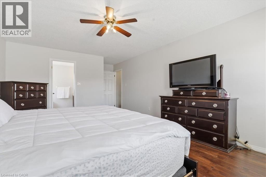 Bedroom featuring wood-finish flooring, a ceiling fan, and light gray wall paint - 136 Carpenter Road, Cambridge, ON - Indoor Photo Showing Bedroom