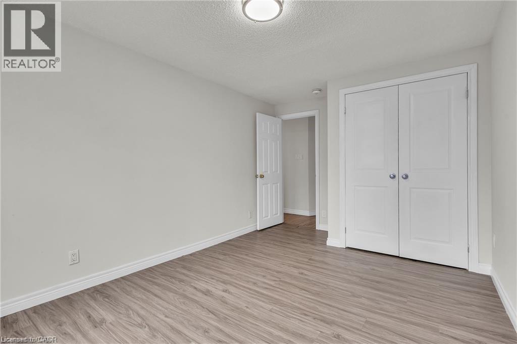 Room featuring wood-finish flooring, white baseboards, and light gray walls - 22 Blackhorne Crescent, Kitchener, ON - Indoor Photo Showing Other Room