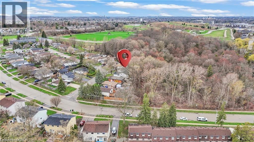 Aerial perspective showcasing a residential neighborhood bordering expansive natural green spaces and mature trees - 22 Blackhorne Crescent, Kitchener, ON - Outdoor With View