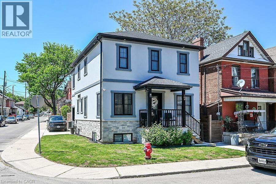 Contemporary two-story residence featuring a light-colored stucco exterior with dark trim accents - 109 Ray Street N, Hamilton, ON - Outdoor With Facade