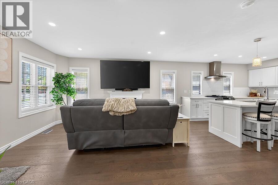 Open-concept living space featuring wood-finish flooring and recessed lighting - 109 Ray Street N, Hamilton, ON - Indoor