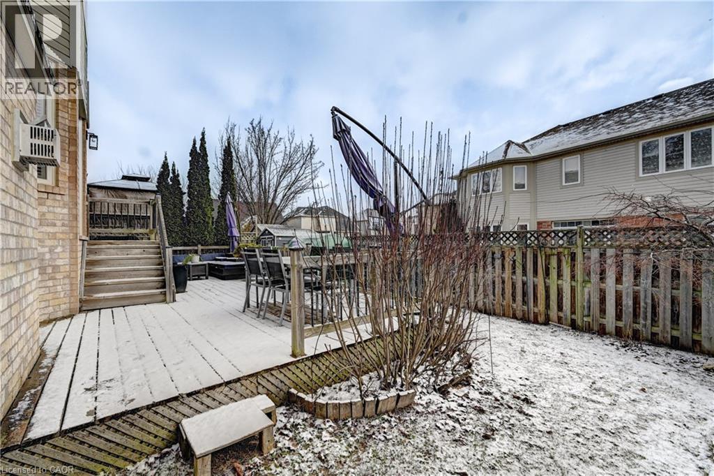 Wooden deck with a fenced backyard and outdoor dining area - 222 Baldwin Drive, Cambridge, ON - Outdoor With Deck Patio Veranda