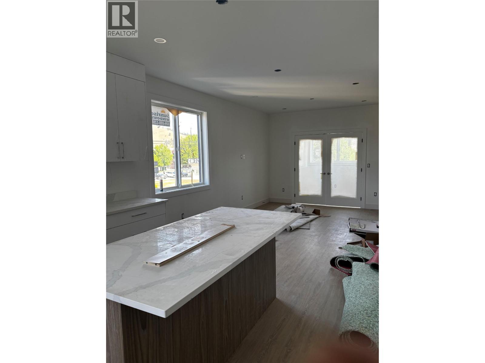 Kitchen living room with extra windows in end unit - 980 Franklyn Road Unit# 6 Lot# 6, Kelowna, BC