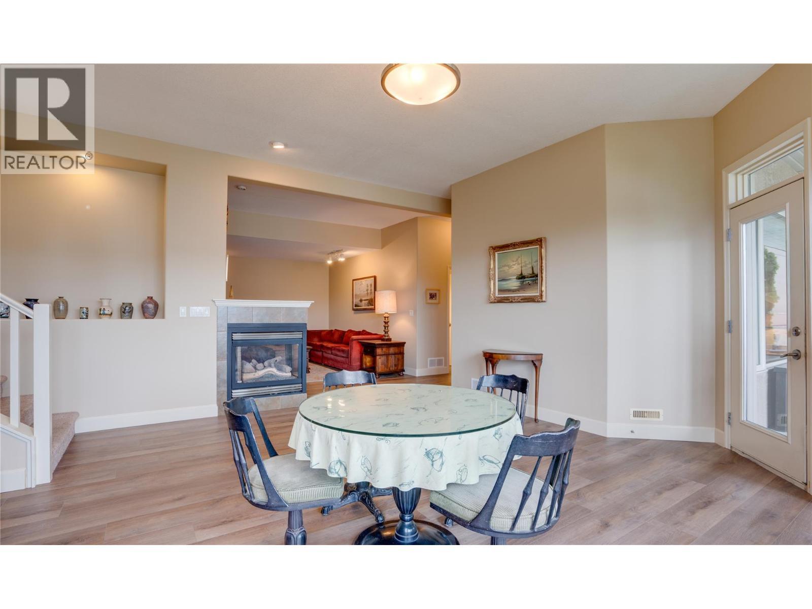 #8 Bayview Heights Lot# 8, Coldstream, BC - Indoor Photo Showing Dining Room With Fireplace