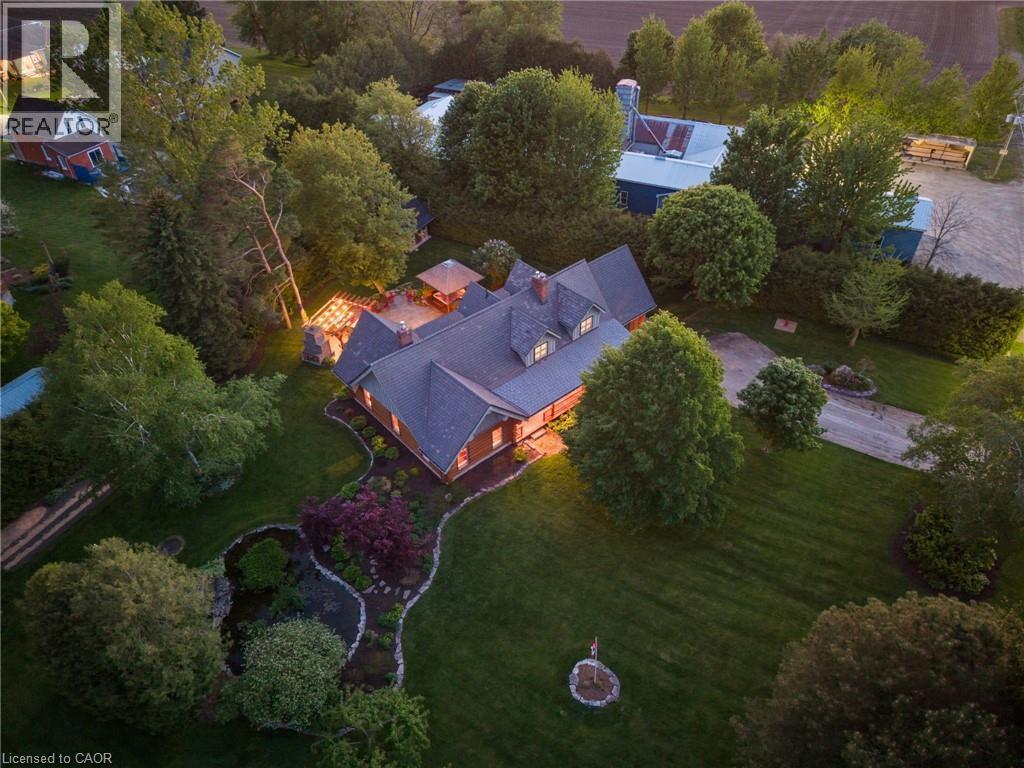 Expansive property featuring a multi-level home with a dark-toned roof and dormer windows - 169 James Street, Atwood, ON - Outdoor With View