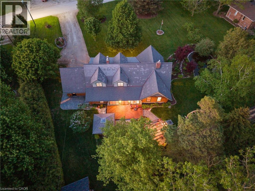 Expansive property featuring a multi-gabled roofline, multiple dormer windows, and a generously sized rear deck - 169 James Street, Atwood, ON - Outdoor With View