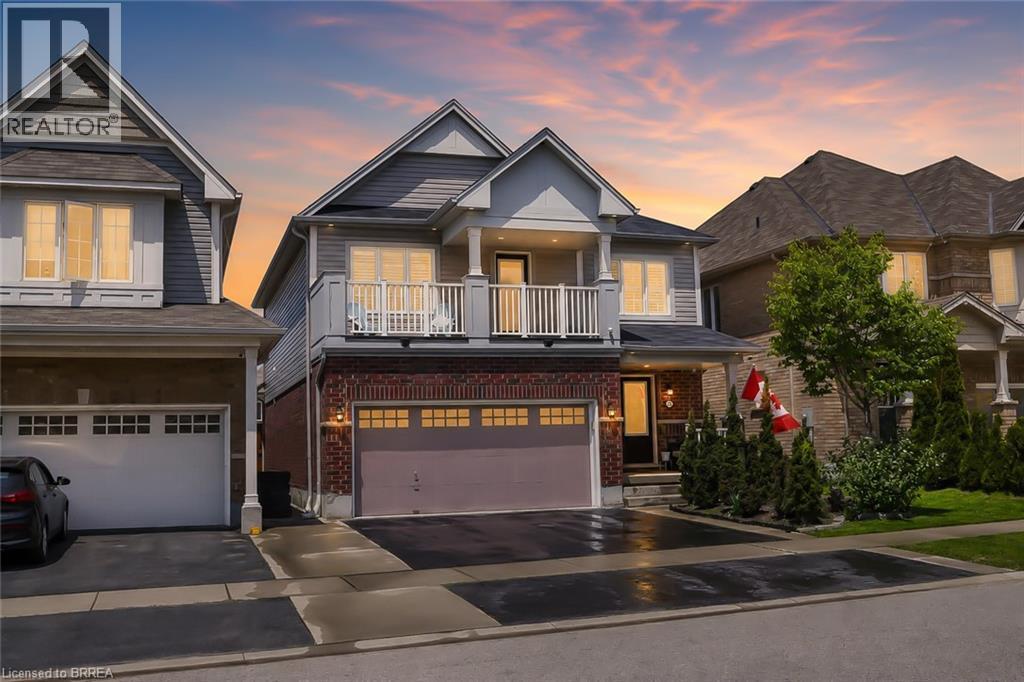 Contemporary two-story residence featuring a brick and siding exterior, an attached two-car garage, and a second-story balcony - 26 Pollard Street, Brantford, ON - Outdoor With Balcony With Facade