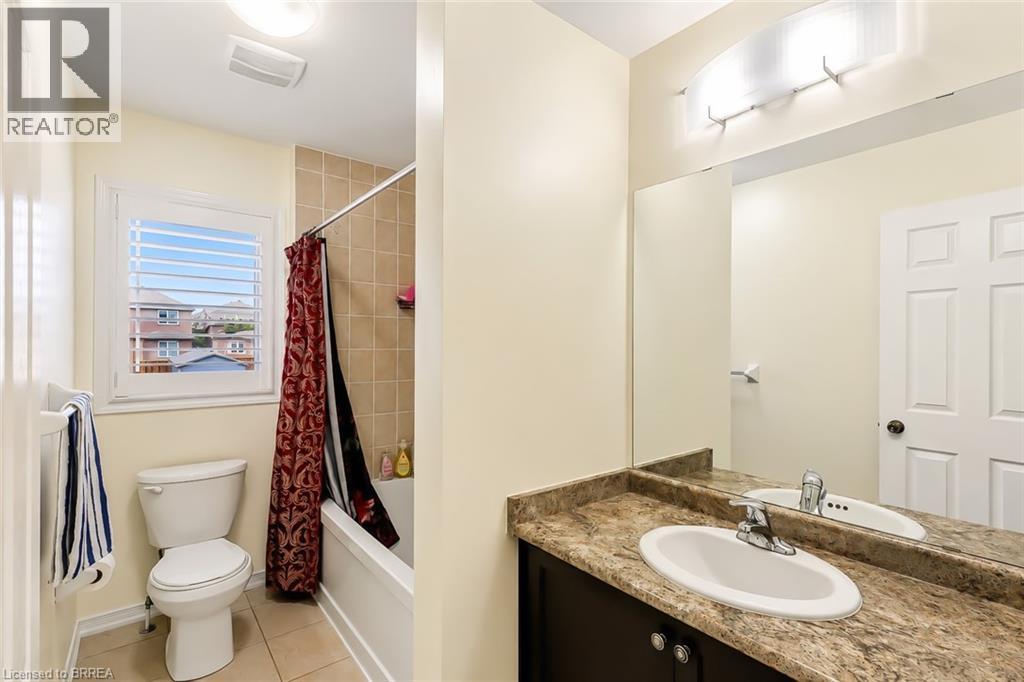Bathroom featuring a built-in vanity with an integrated sink and a large wall mirror - 26 Pollard Street, Brantford, ON - Indoor Photo Showing Bathroom