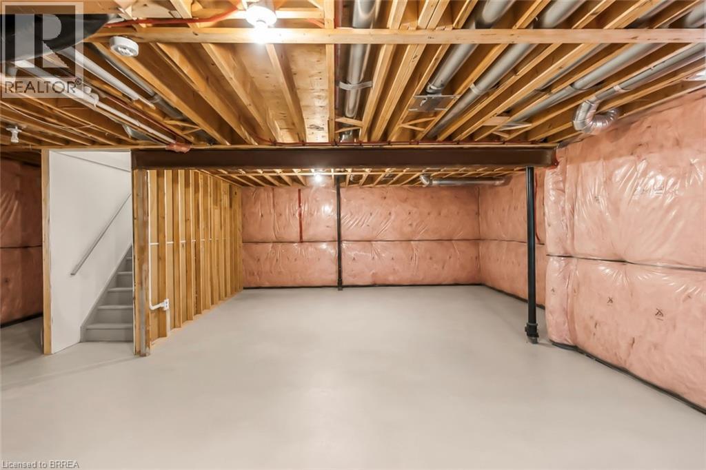 Unfinished basement space featuring exposed wood joists, insulated walls, and a concrete floor - 26 Pollard Street, Brantford, ON - Indoor Photo Showing Basement