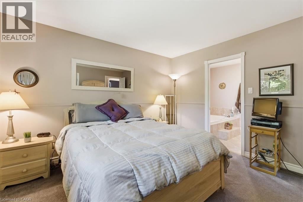 Carpeted bedroom with neutral wall tones and white trim - 26 Sideroad 18, Fergus, ON - Indoor Photo Showing Bedroom