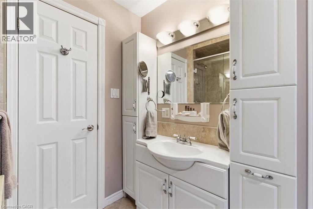 White paneled cabinetry and vanity with integrated sink - 26 Sideroad 18, Fergus, ON - Indoor
