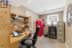 Dedicated office space featuring built-in wood shelving and desk, recessed lighting, and tile flooring -