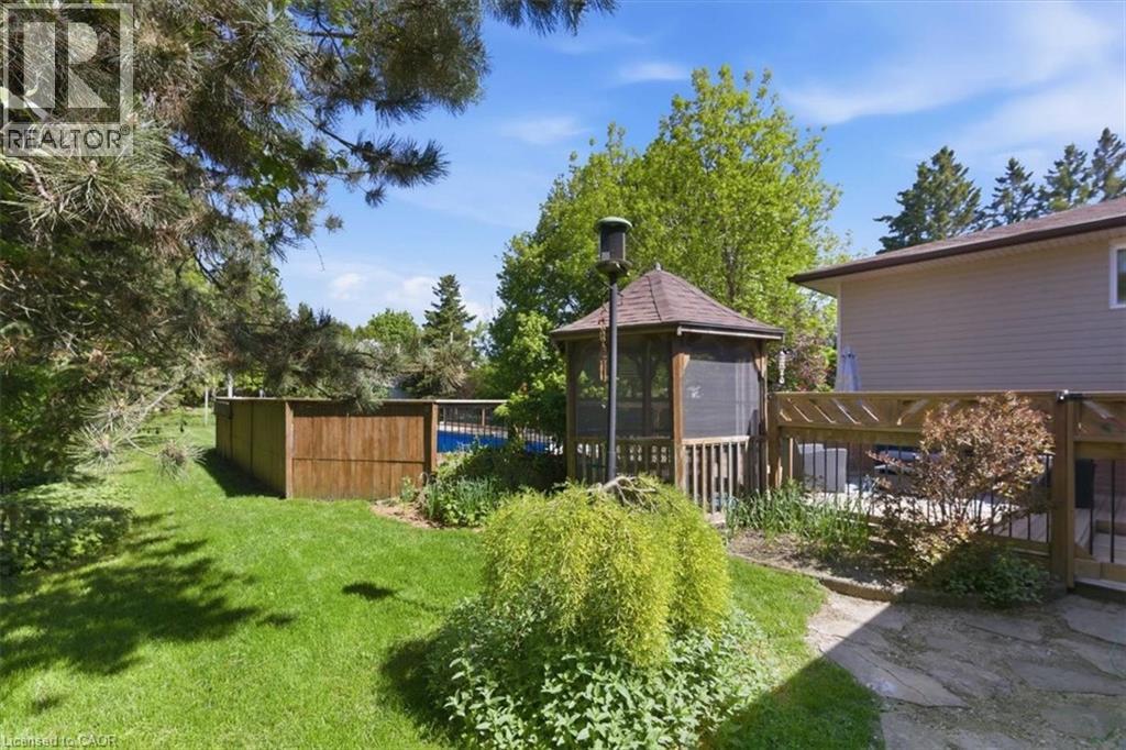 Expansive backyard featuring a screened gazebo, a swimming pool, and a stone patio - 26 Sideroad 18, Fergus, ON - Outdoor