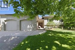 Stone facade featuring a two-car garage with arched entrances -