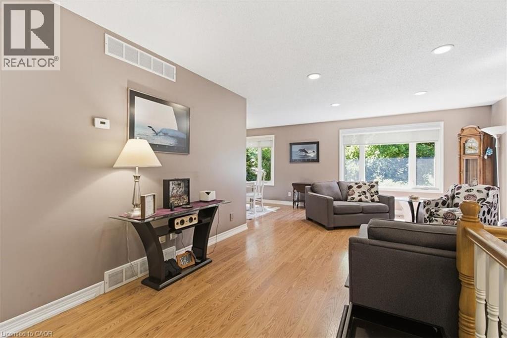 Spacious living area featuring wood-finish flooring, recessed ceiling lighting, and large windows - 26 Sideroad 18, Fergus, ON - Indoor Photo Showing Living Room
