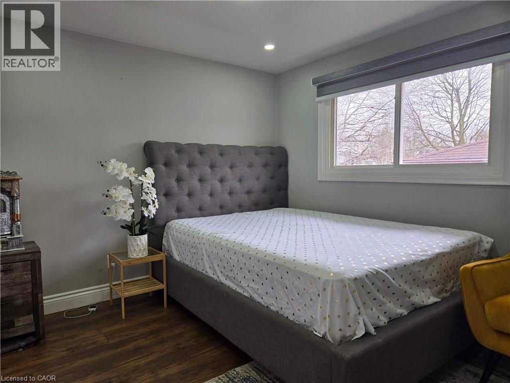 Recessed lighting illuminates this room featuring wood-finish flooring - 261 Overlea Drive, Kitchener, ON
