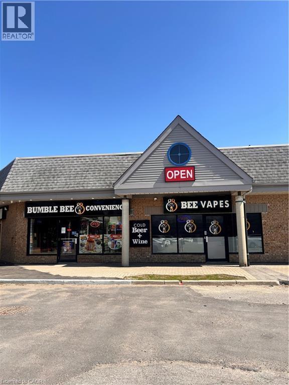 Commercial storefront with a gabled facade featuring horizontal siding and a circular accent window - 1400 Weber Street E Unit# A5, Kitchener, ON