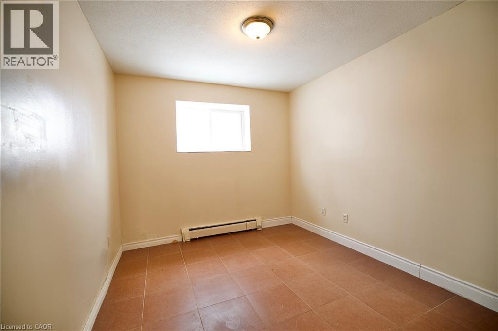 Room featuring square tile flooring and neutral painted walls - 223 Heiman Street Unit# Unit 2, Kitchener, ON - Indoor Photo Showing Other Room