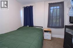 Carpeted room featuring white walls and multiple windows -