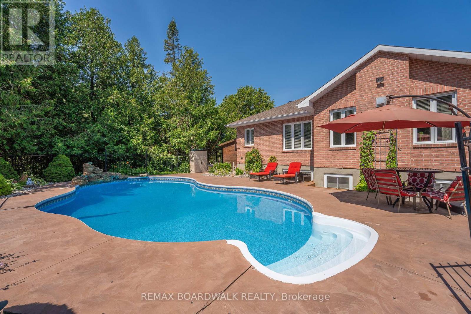 Heated Inground Pool w/a Striking Waterfall - 14 Panandrick View Drive, Ottawa, ON