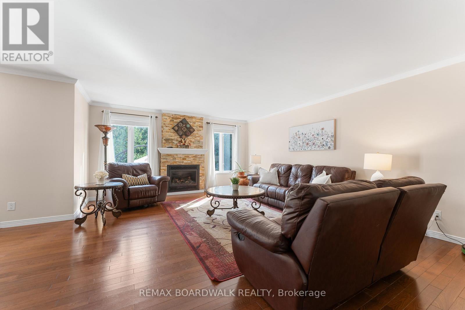 Living Room w/Gas Fireplace & Large Windows - 14 Panandrick View Drive, Ottawa, ON