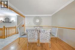 Hardwood flooring paired with light gray walls and white crown molding -