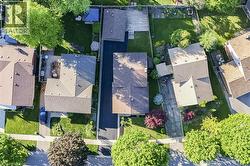 Aerial perspective showcasing a residential property with a multi-gabled roofline and a substantial driveway -
