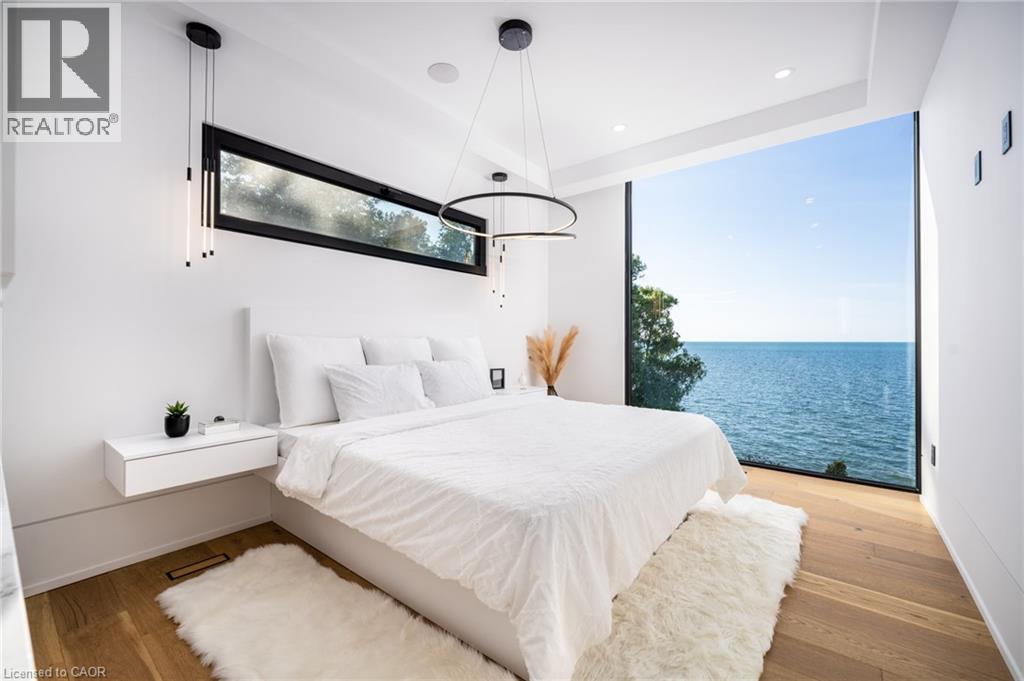 Expansive floor-to-ceiling window showcasing water scenery - 6 Firelane 11A Street, Niagara-On-The-Lake, ON - Indoor Photo Showing Bedroom