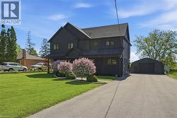 Dark-toned multi-story exterior with a gabled roofline -