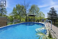 Above-ground pool featuring integrated steps and a surrounding composite deck -