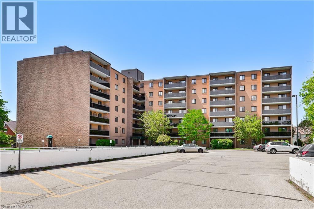 Multi-story residential building featuring a brick exterior and private balconies - 29 West Avenue, Kitchener, ON