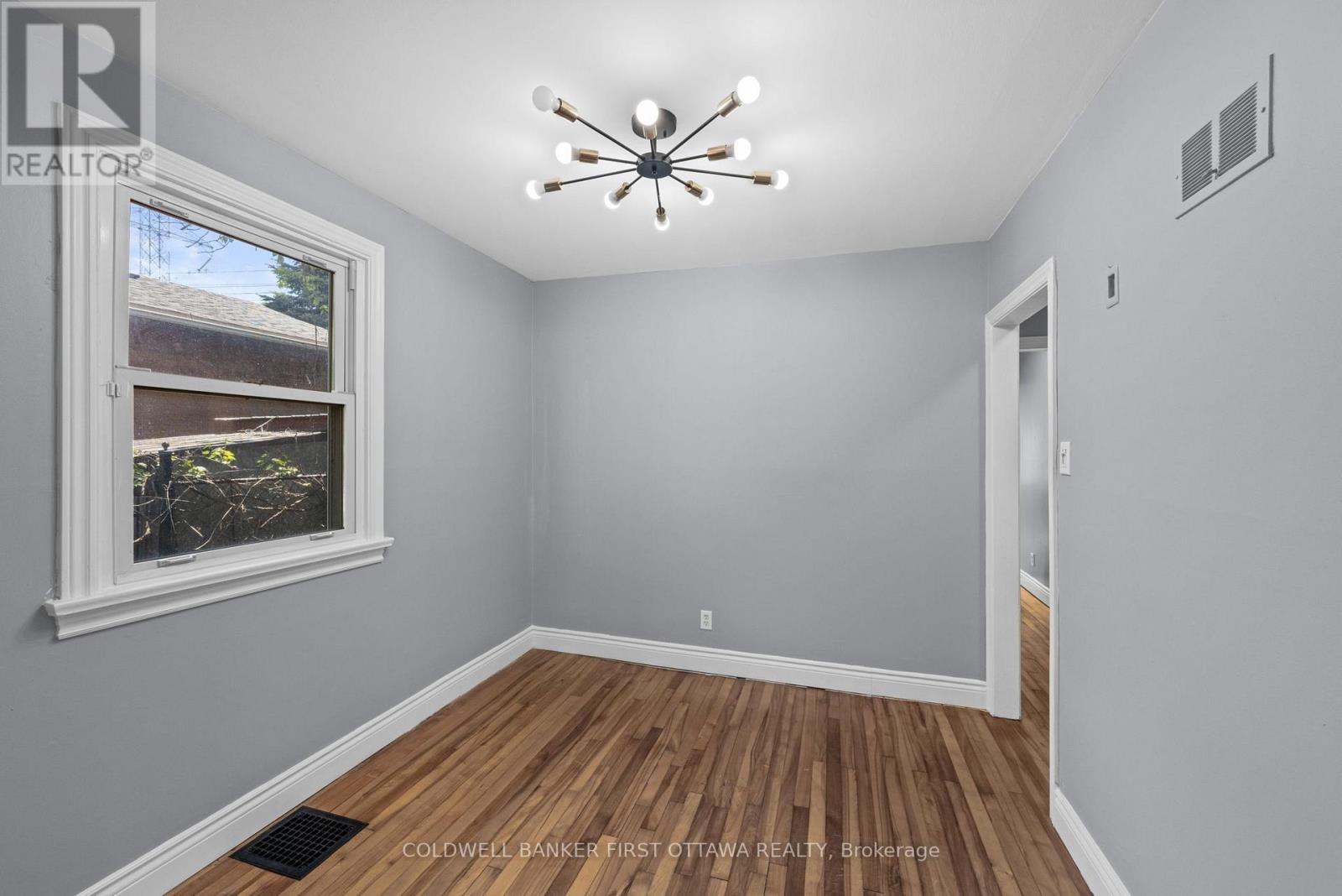 Dining room w window & modern fixture above. - 1246 Kitchener Avenue, Ottawa, ON