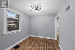 Dining room w window & modern fixture above. -