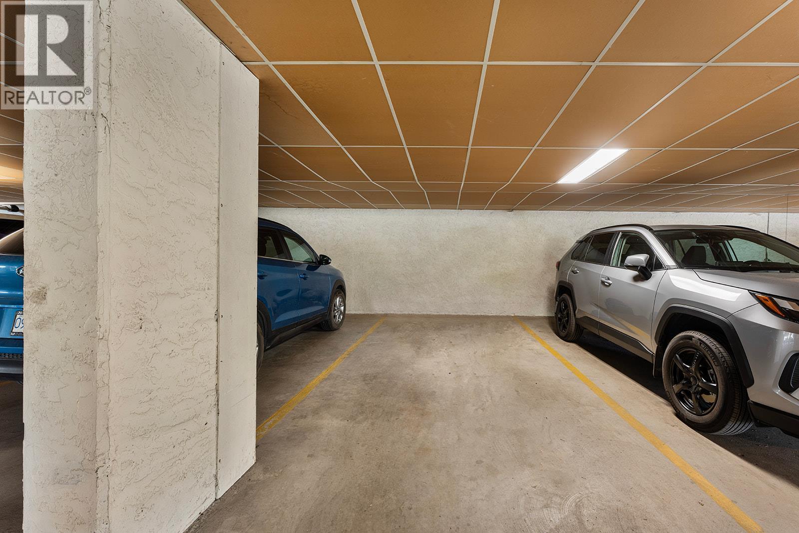 Your parking spot! - 1534 Lawrence Avenue Unit# 304, Kelowna, BC - Indoor Photo Showing Garage