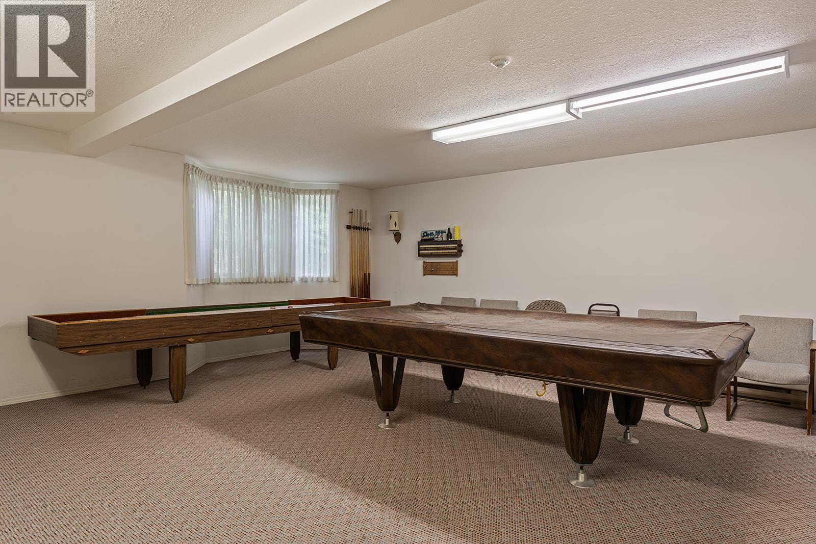Enjoy a game of pool located Rec room, which also has a kitchen. - 1534 Lawrence Avenue Unit# 304, Kelowna, BC - Indoor Photo Showing Other Room