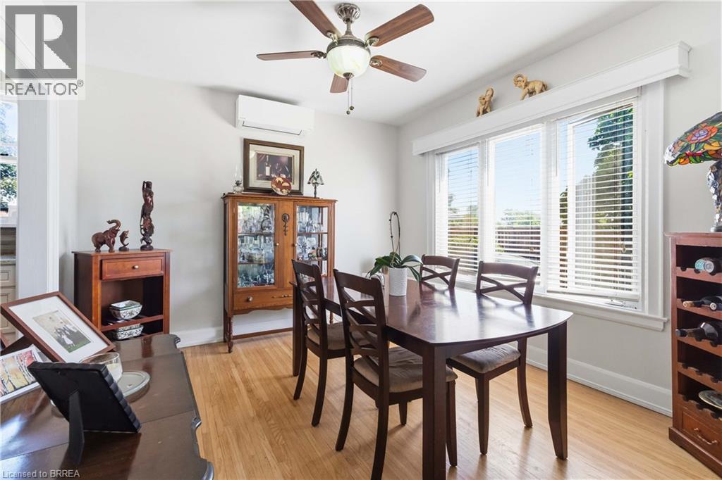 Dining area featuring light wood-finish flooring and a multi-pane window with blinds - 134 Queensway Drive, Brantford, ON