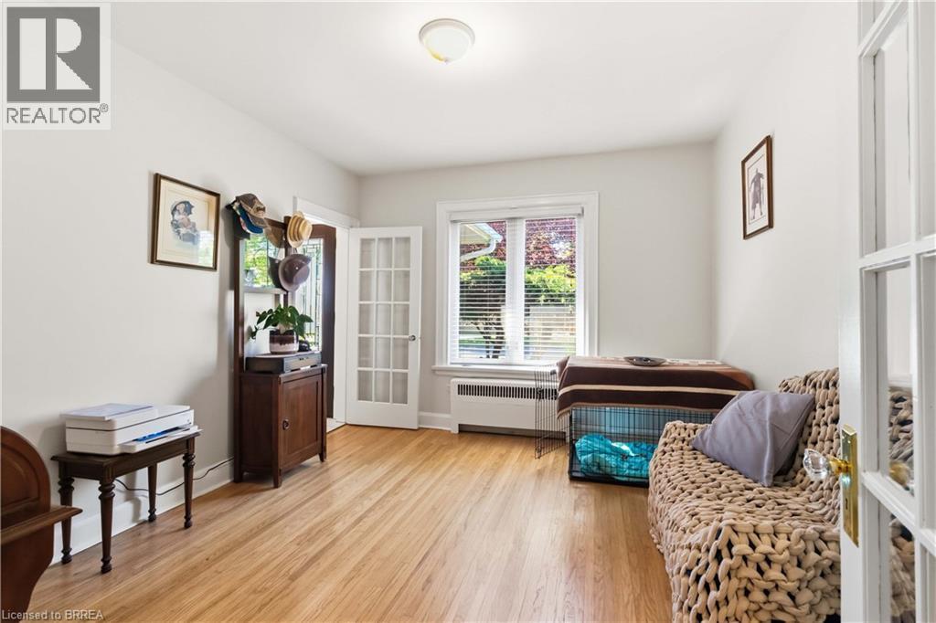 Room featuring wood-finish flooring, white painted walls, and recessed lighting - 134 Queensway Drive, Brantford, ON