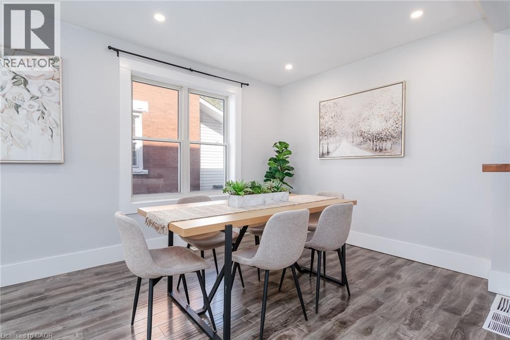 Dining area featuring wood-finish flooring, recessed lighting, and a white trim window - 40 Woodland Avenue, Kitchener, ON