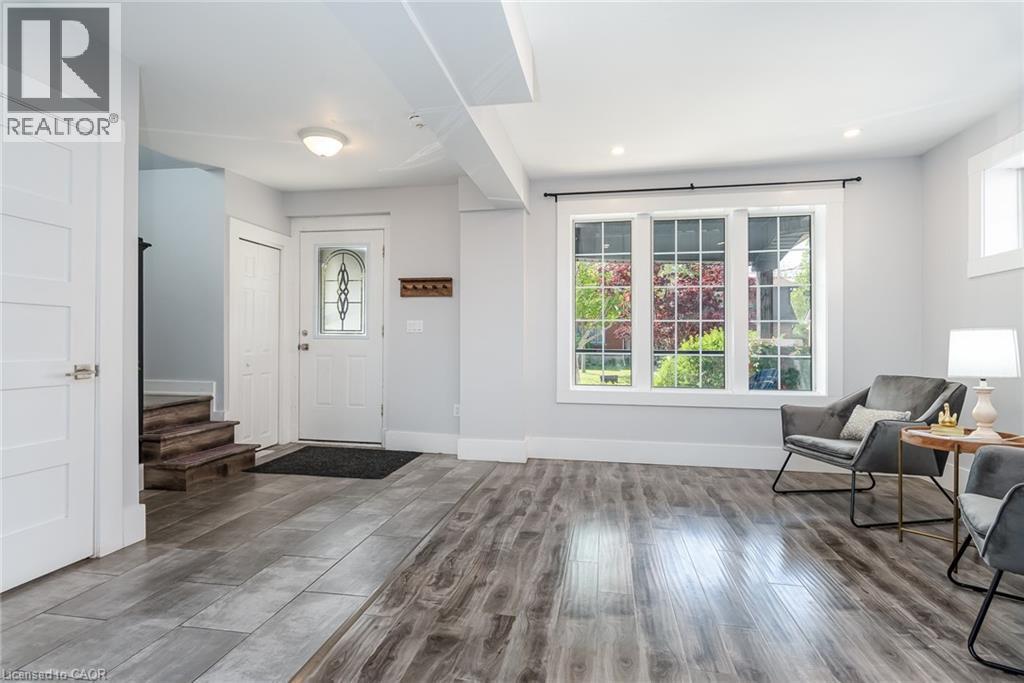 Kitchenette featuring white cabinetry, stainless steel appliances, wood-finish flooring, and recessed lighting - 40 Woodland Avenue, Kitchener, ON