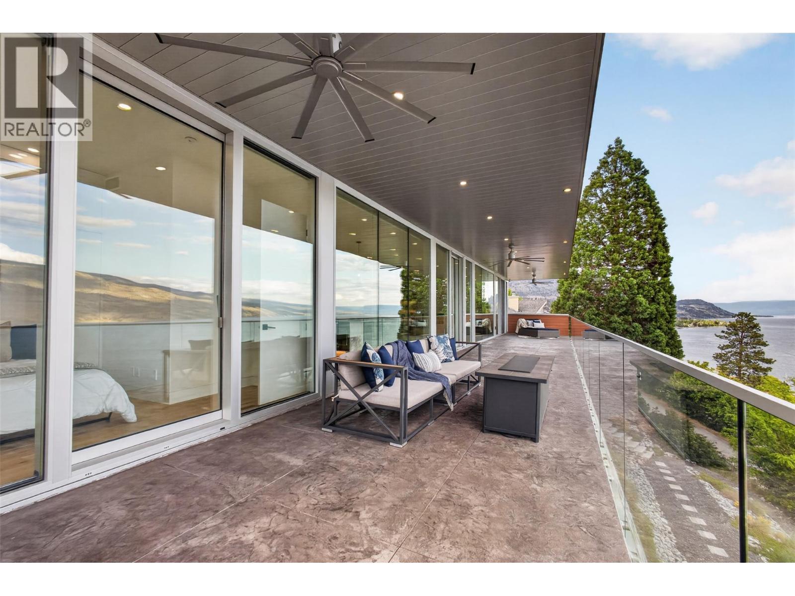 The main upper deck measures approximately 10.5 ft. x 74 ft. 10 in. (roughly 785 sq. ft.) and spans beyond the full width of the home. - 5835 Vicary Road, Peachland, BC