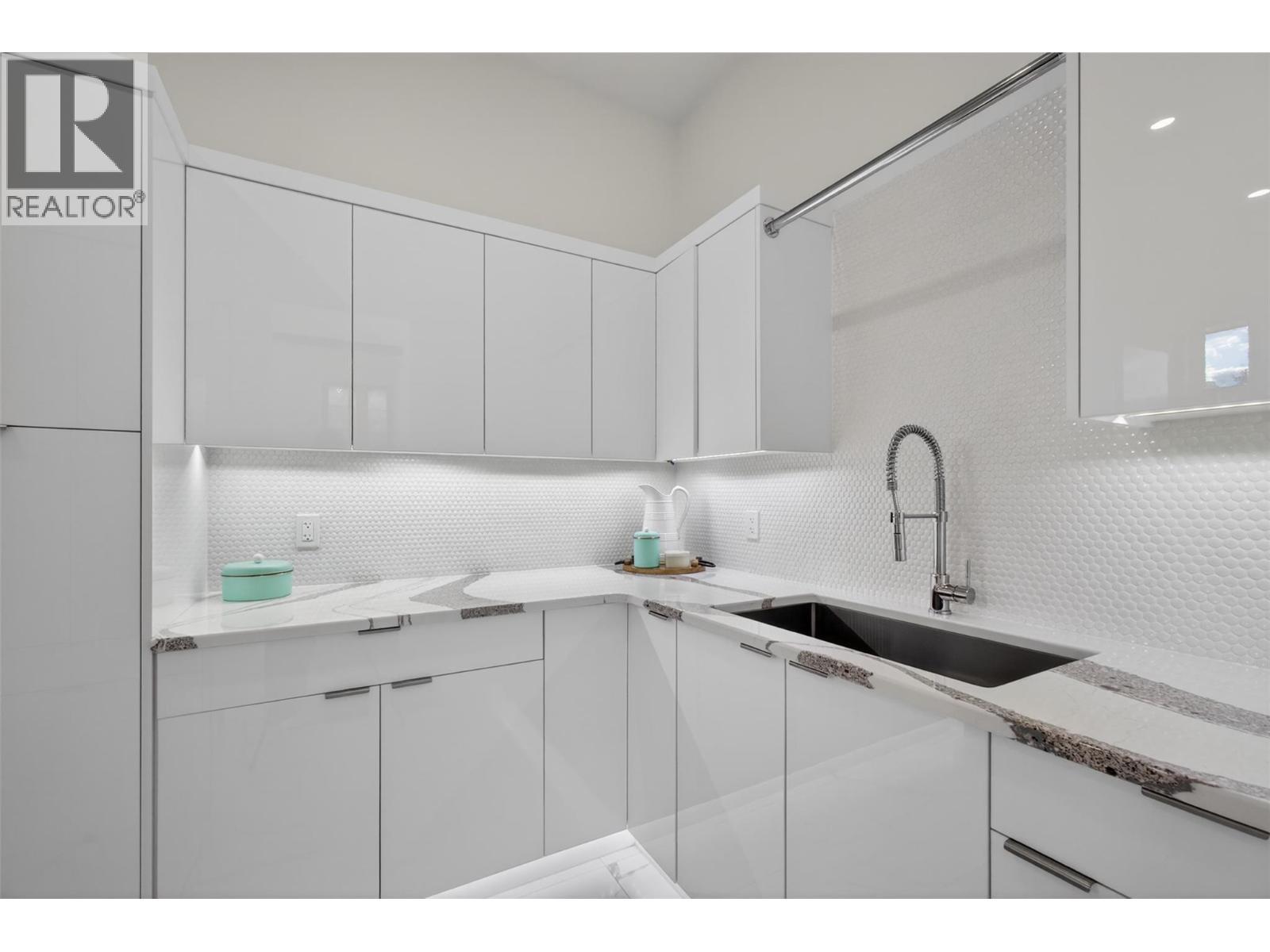 Large laundry area on the main with endless storage - 5835 Vicary Road, Peachland, BC