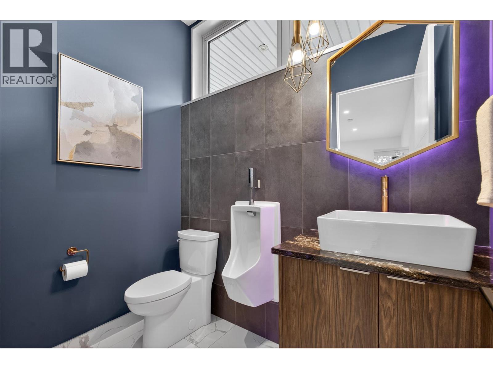 Literal gold flake-infused countertops to go along with a top-of-the-line urinal located directly off the garage. - 5835 Vicary Road, Peachland, BC